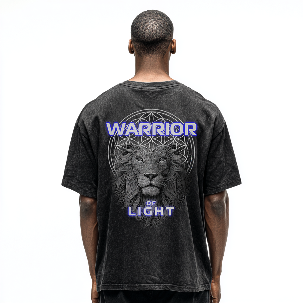 Third Journey black acid-wash t-shirt worn by model, featuring lion artwork and “Warrior of Light” text with spiritual symbolism