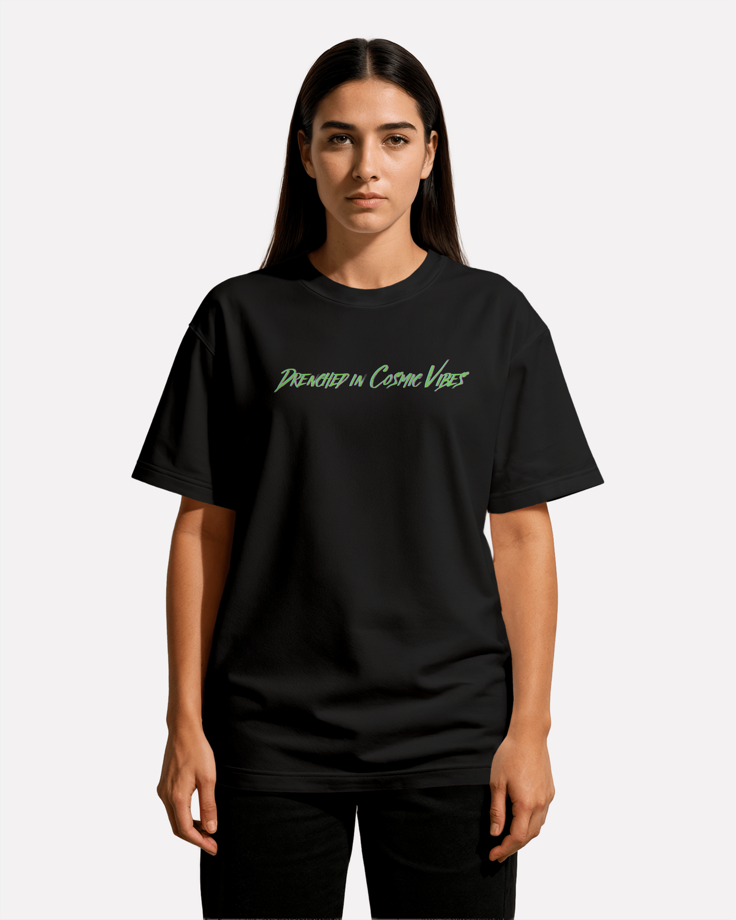 model wearing Third Journey black t-shirt featuring “Drenched in Cosmic Vibes” text in neon green and purple tones