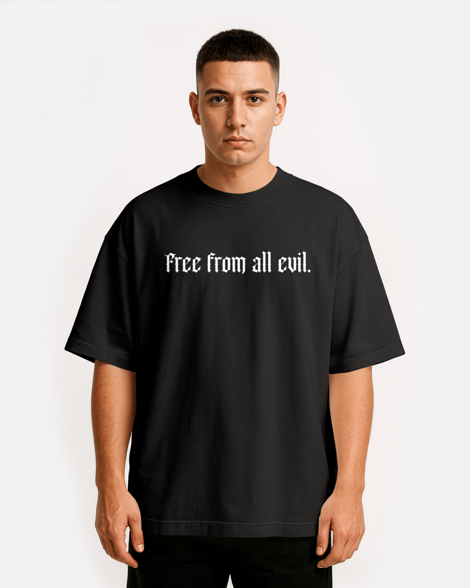 model wearing Third Journey black drop shoulder t-shirt with minimalist gothic text “Free from all evil” on the front