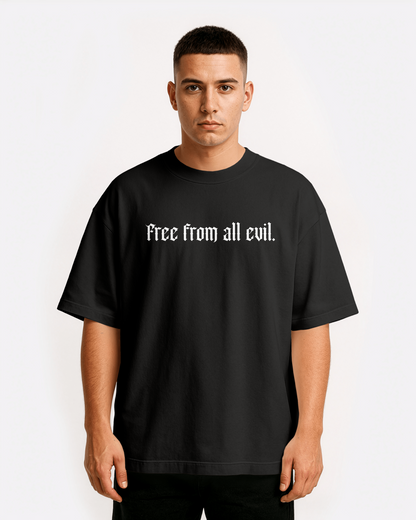 model wearing Third Journey black drop shoulder t-shirt with minimalist gothic text “Free from all evil” on the front
